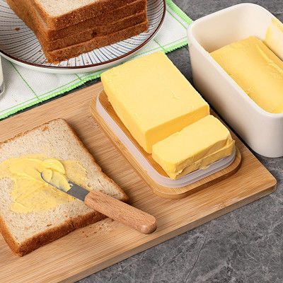 Piatto di burro ceramico bianco con il coperchio ed il coltello per il contatore di cucina