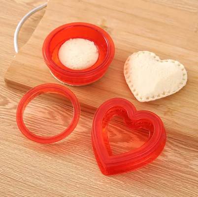 Gli strumenti della cucina agglutinano la taglierina ed il sigillatore del panino del pranzo del biscotto del creatore DIY