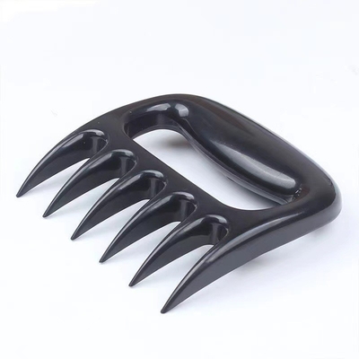 La trinciatrice di plastica all'aperto della carne degli strumenti e degli accessori del BARBECUE graffia l'orso